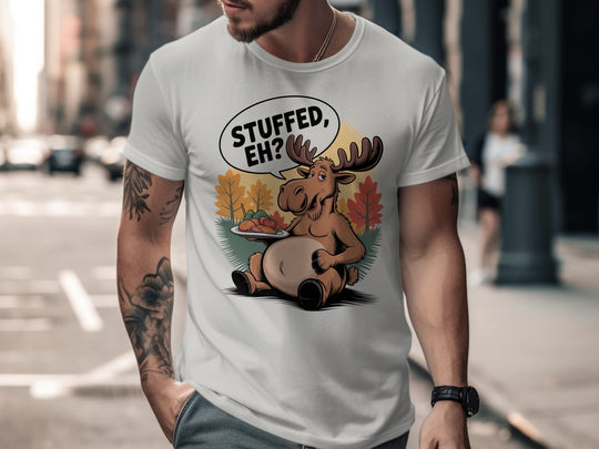 Canadian Thanksgiving men’s T-shirt with cartoon moose saying “Stuffed, Eh?” amid fall trees