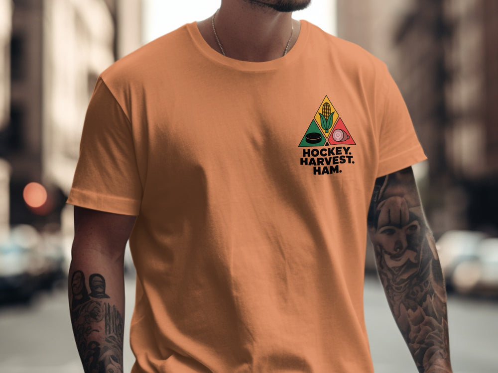 Hockey Thanksgiving men’s T-shirt with “Hockey. Harvest. Ham.” triangle corn, puck, and ham design