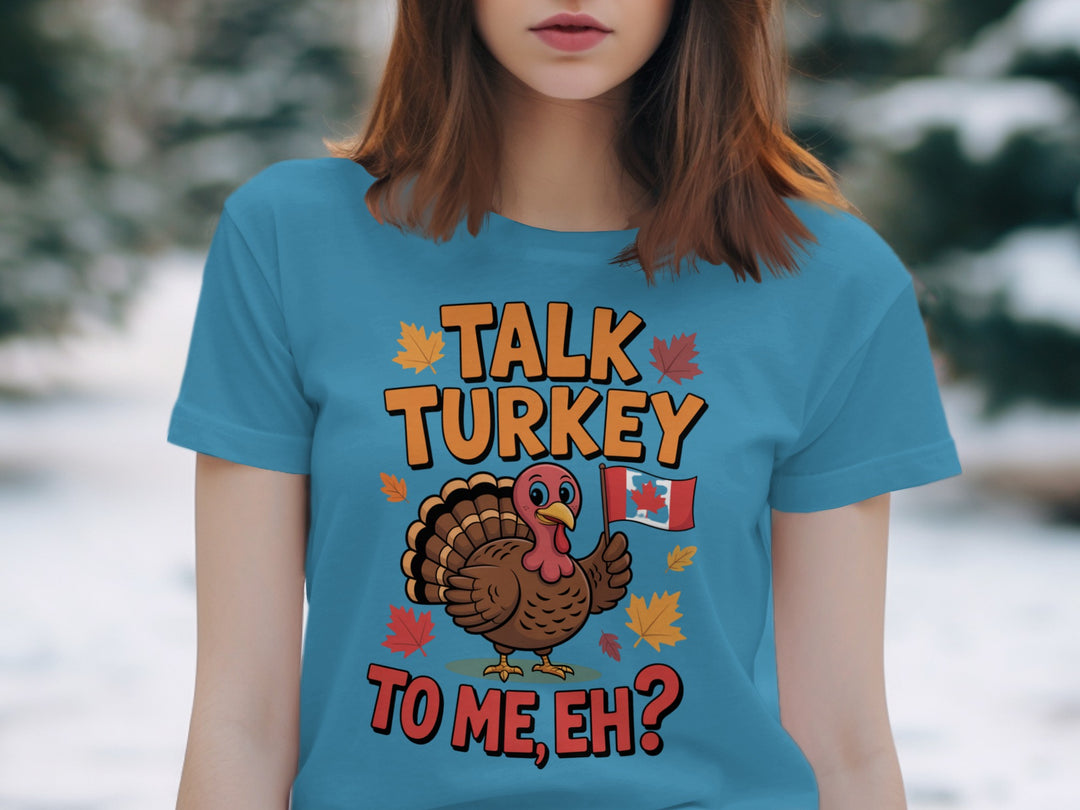 women's thanksgiving t-shirt with “talk turkey to me, eh?” turkey holding canadian flag and maple leaves