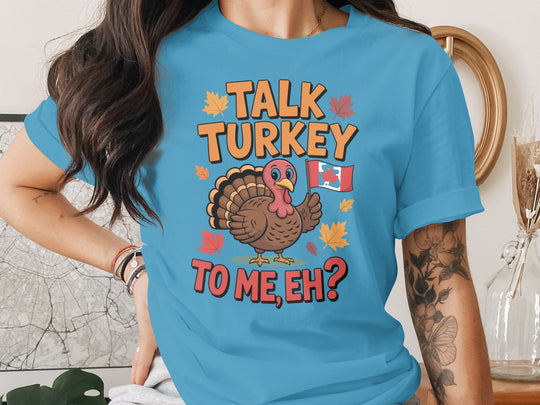 women's thanksgiving t-shirt with “talk turkey to me, eh?” turkey holding canadian flag and maple leaves