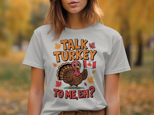 women's thanksgiving t-shirt with “talk turkey to me, eh?” turkey holding canadian flag and maple leaves