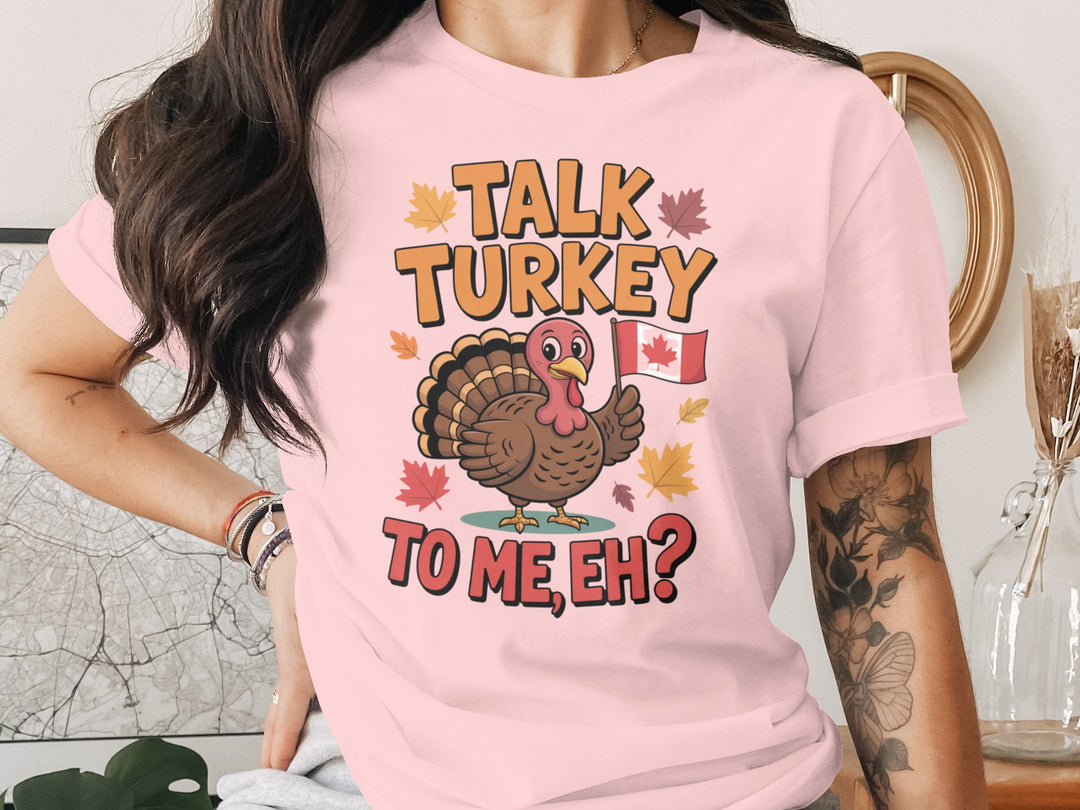 women's thanksgiving t-shirt with “talk turkey to me, eh?” turkey holding canadian flag and maple leaves