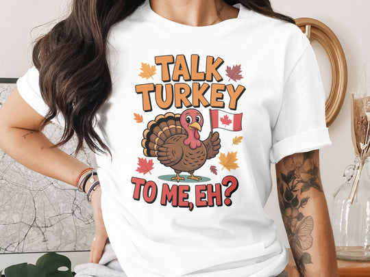 women's thanksgiving t-shirt with “talk turkey to me, eh?” turkey holding canadian flag and maple leaves