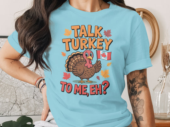 women's thanksgiving t-shirt with “talk turkey to me, eh?” turkey holding canadian flag and maple leaves