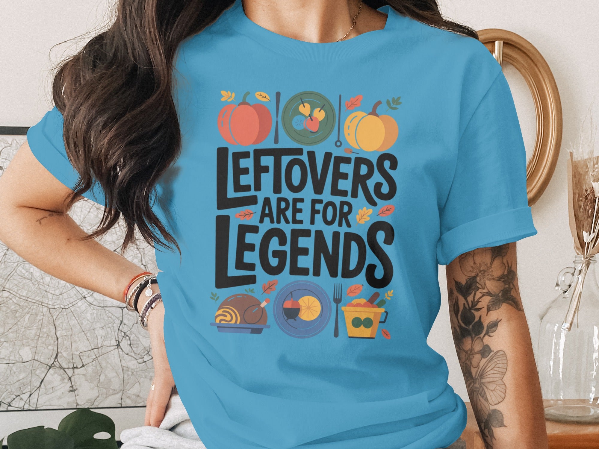 women's thanksgiving t-shirt with 'leftovers are for legends' pumpkins and feast icons graphic