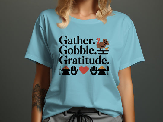 women’s thanksgiving t-shirt with “gather gobble gratitude” turkey and pies graphic