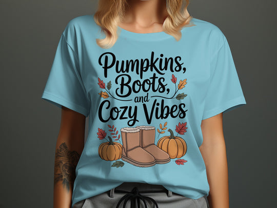 women's thanksgiving t-shirt with “pumpkins, boots, and cozy vibes” pumpkins and boots graphic