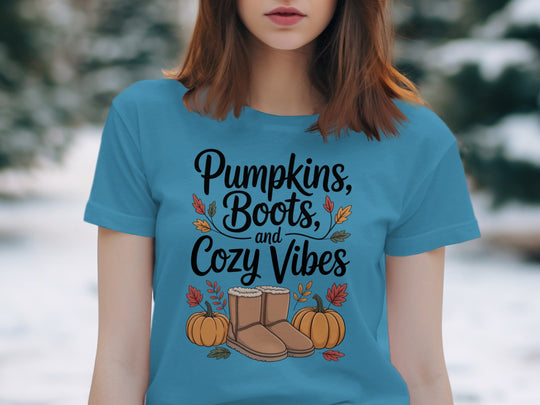 women's thanksgiving t-shirt with “pumpkins, boots, and cozy vibes” pumpkins and boots graphic