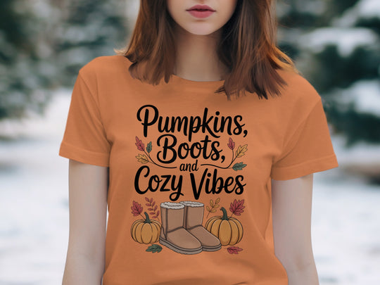 women's thanksgiving t-shirt with “pumpkins, boots, and cozy vibes” pumpkins and boots graphic