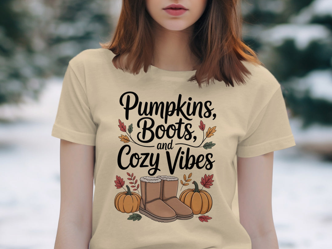 women's thanksgiving t-shirt with “pumpkins, boots, and cozy vibes” pumpkins and boots graphic