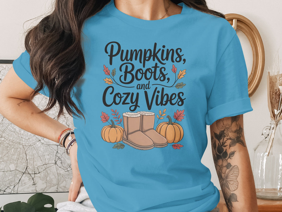 women's thanksgiving t-shirt with “pumpkins, boots, and cozy vibes” pumpkins and boots graphic