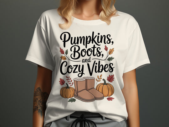 women's thanksgiving t-shirt with “pumpkins, boots, and cozy vibes” pumpkins and boots graphic