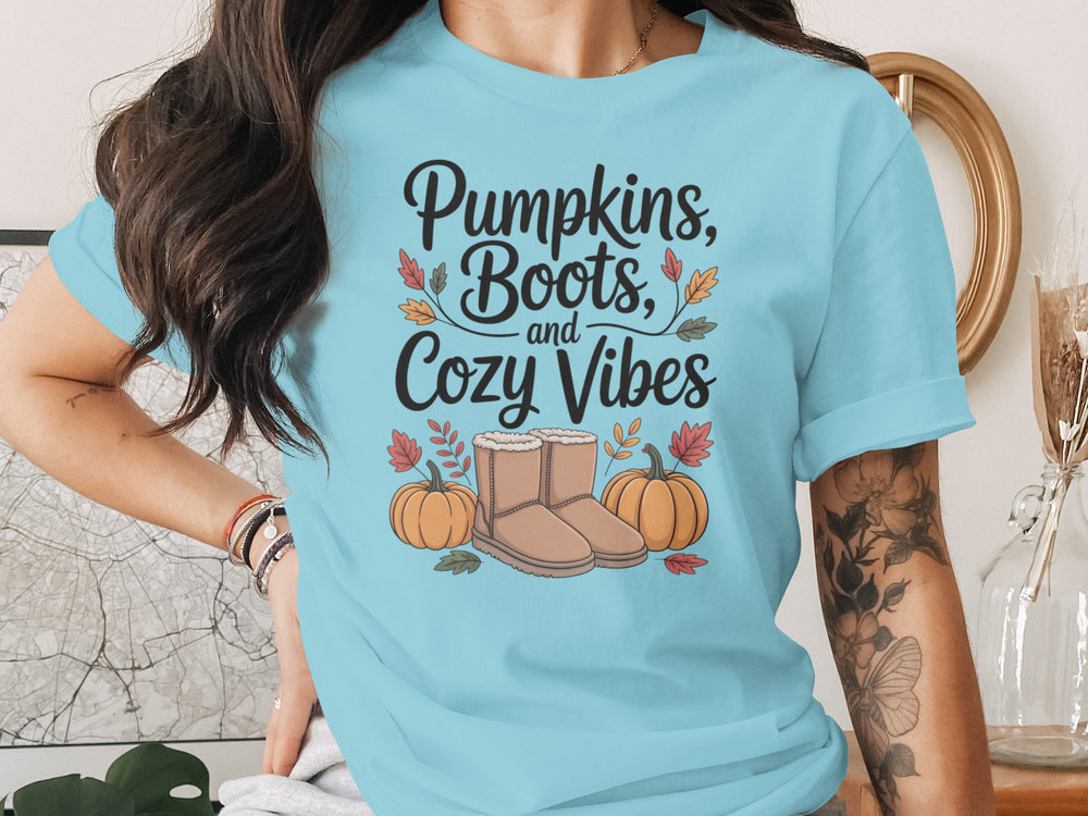 women's thanksgiving t-shirt with “pumpkins, boots, and cozy vibes” pumpkins and boots graphic