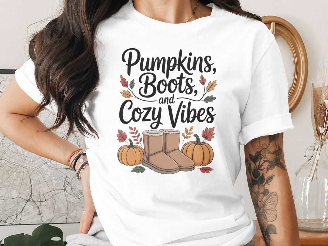 women's thanksgiving t-shirt with “pumpkins, boots, and cozy vibes” pumpkins and boots graphic