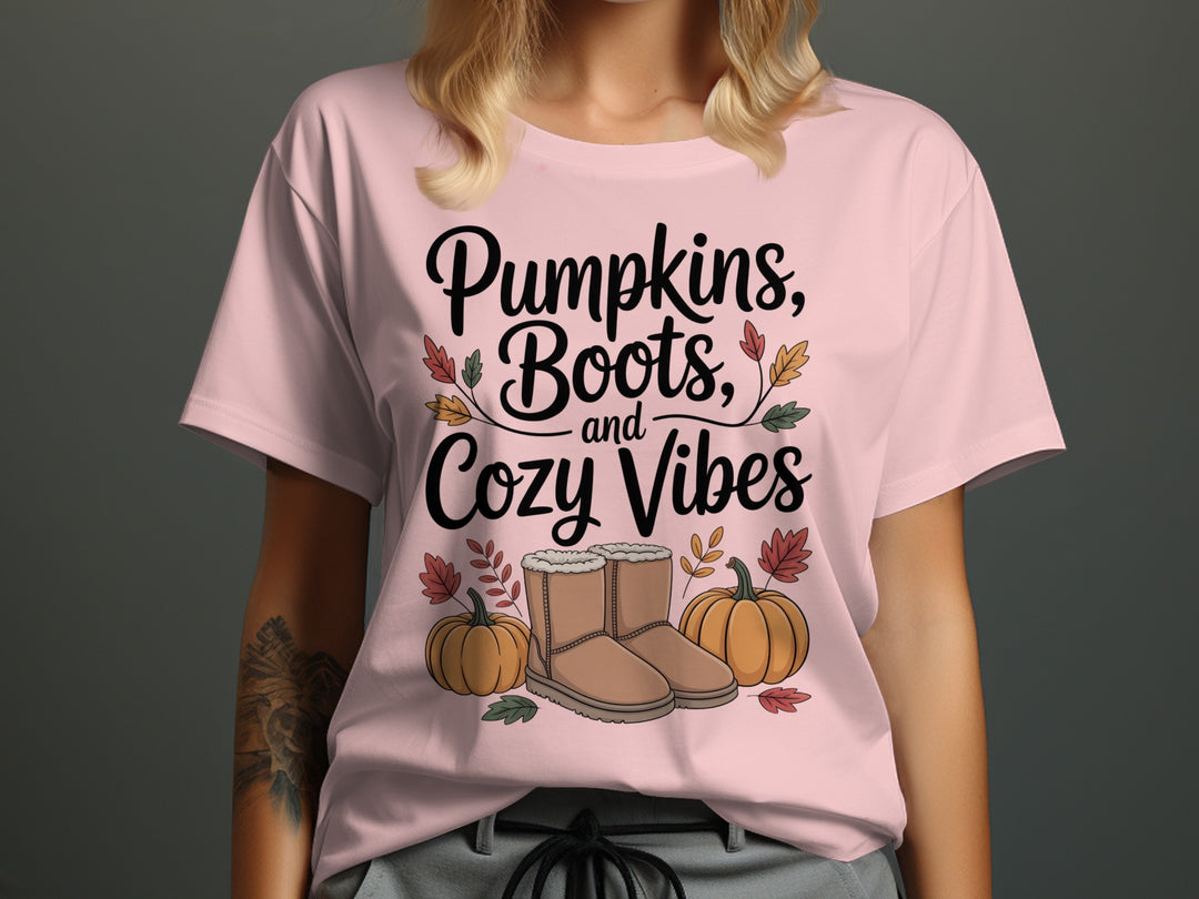 women's thanksgiving t-shirt with “pumpkins, boots, and cozy vibes” pumpkins and boots graphic