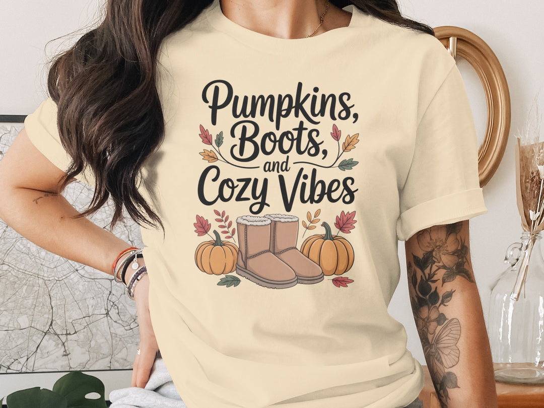 women's thanksgiving t-shirt with “pumpkins, boots, and cozy vibes” pumpkins and boots graphic