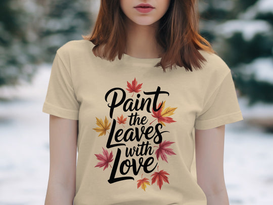 women’s thanksgiving t-shirt with “paint the leaves with love” maple leaves graphic