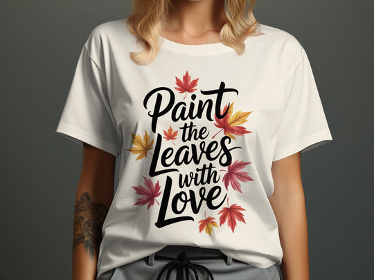 women’s thanksgiving t-shirt with “paint the leaves with love” maple leaves graphic