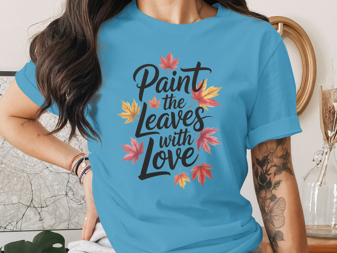 women’s thanksgiving t-shirt with “paint the leaves with love” maple leaves graphic
