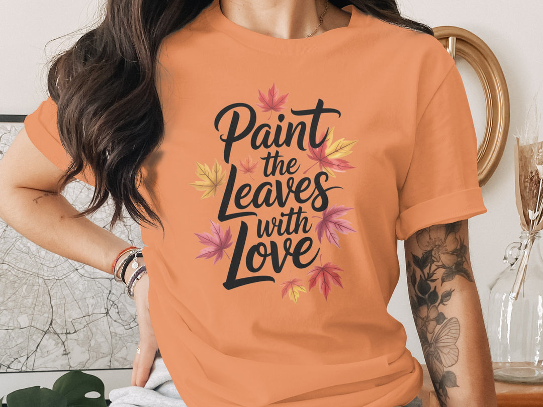 women’s thanksgiving t-shirt with “paint the leaves with love” maple leaves graphic