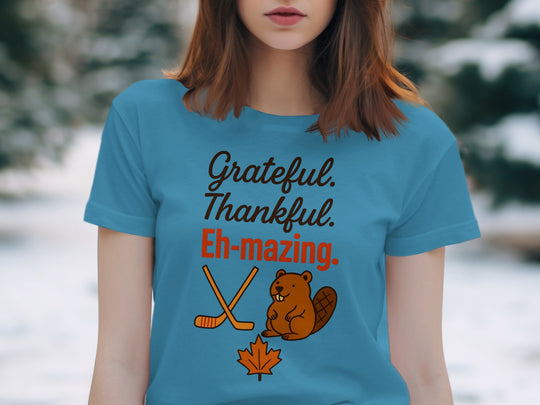 women's thanksgiving t-shirt with 'grateful thankful eh-mazing' beaver, hockey sticks and maple leaf graphic