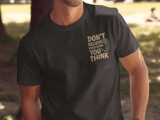 funny men's t-shirt with “don't believe everything you think” quote and spiral head graphic