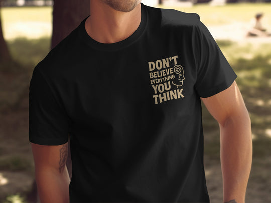funny men's t-shirt with “don't believe everything you think” quote and spiral head graphic