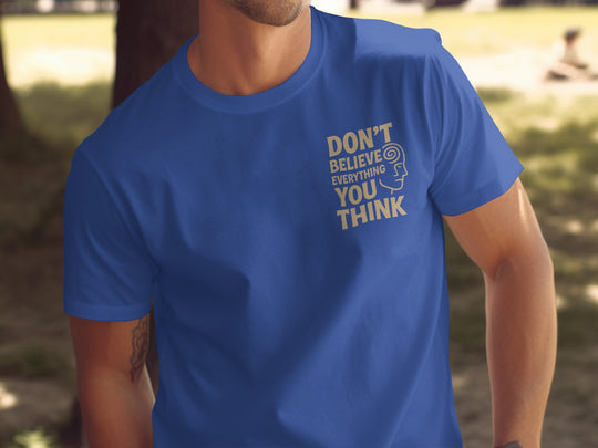 funny men's t-shirt with “don't believe everything you think” quote and spiral head graphic