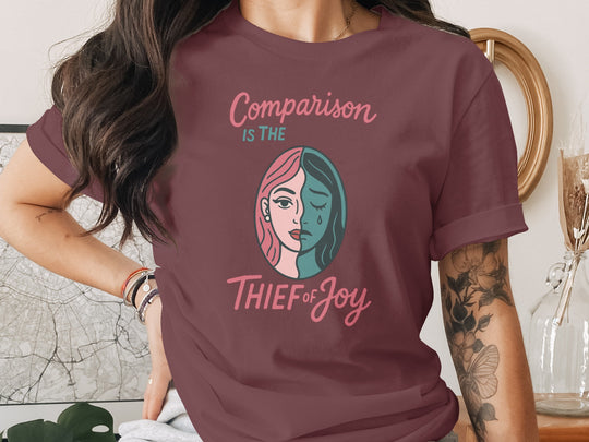 comparison is the thief of joy split-portrait graphic — women’s t-shirt