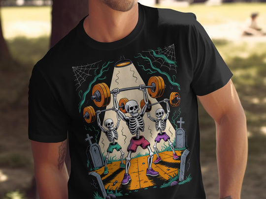 Halloween T-shirt for men with skeletons lifting barbells in a graveyard graphic