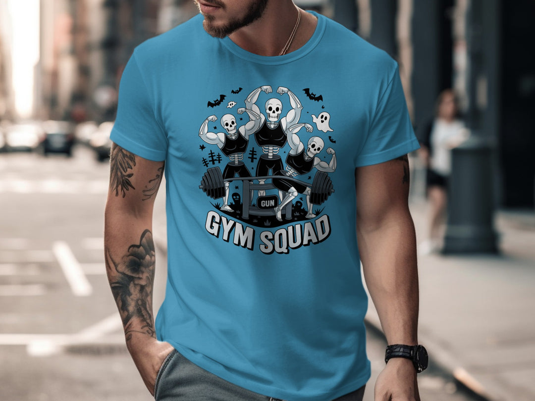 Halloween T-shirt for men with skeletons flexing around a heavy barbell, “Gym Squad” text