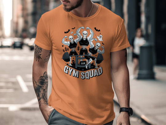 Halloween T-shirt for men with skeletons flexing around a heavy barbell, “Gym Squad” text