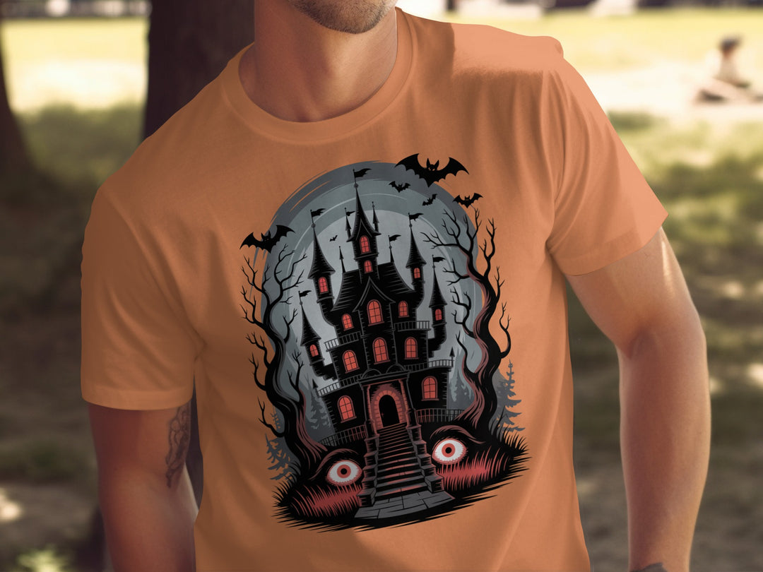 Halloween T-shirt for men with haunted mansion, red windows, bats and eerie eyes graphic