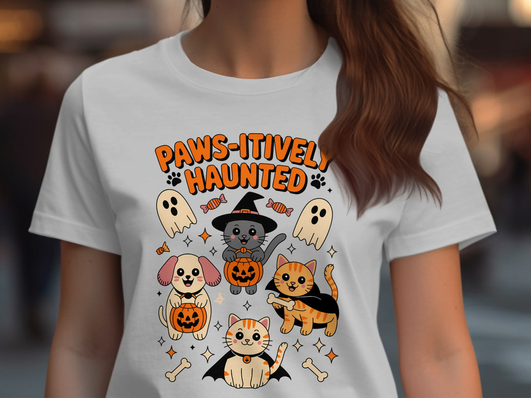 Women’s Halloween T-shirt with “Paws-itively Haunted” cats, dog, pumpkins and ghosts graphic