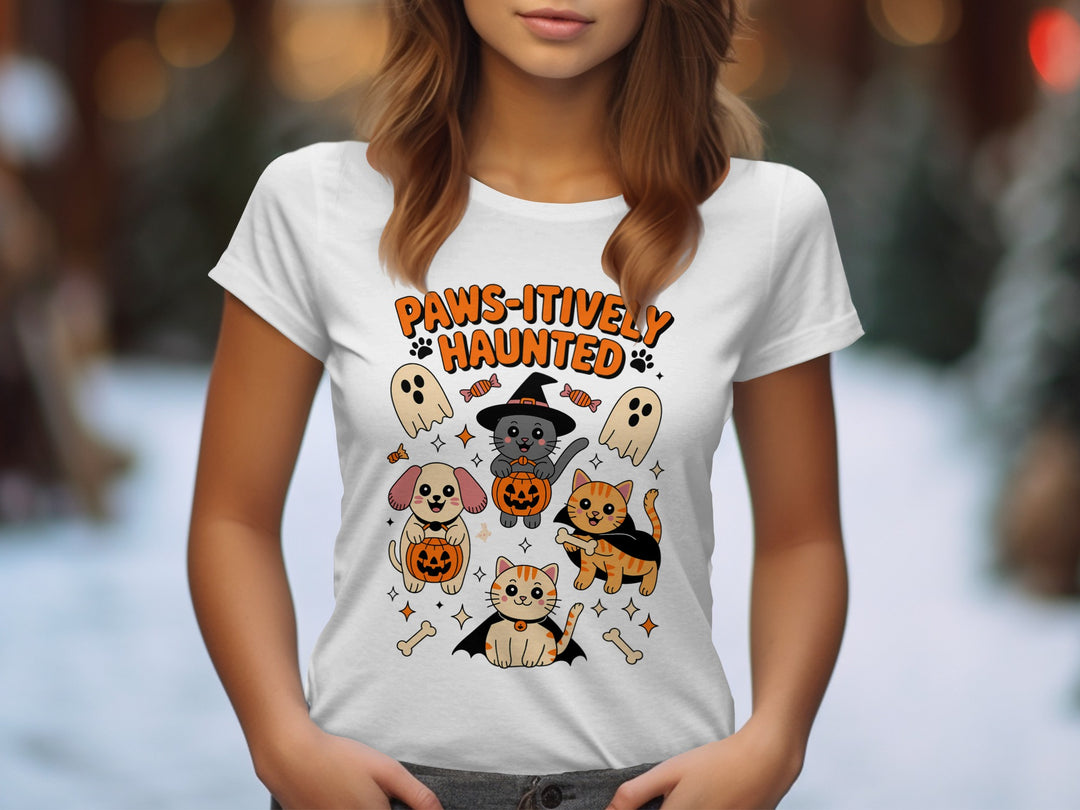 Women’s Halloween T-shirt with “Paws-itively Haunted” cats, dog, pumpkins and ghosts graphic