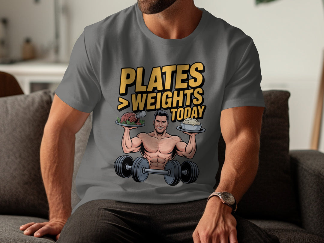 Person wearing a charcoal t-shirt with a graphic design and text, sitting on a couch.