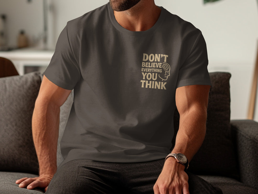 Person wearing a dark chocolate t-shirt with a motivational quote sitting on a couch.