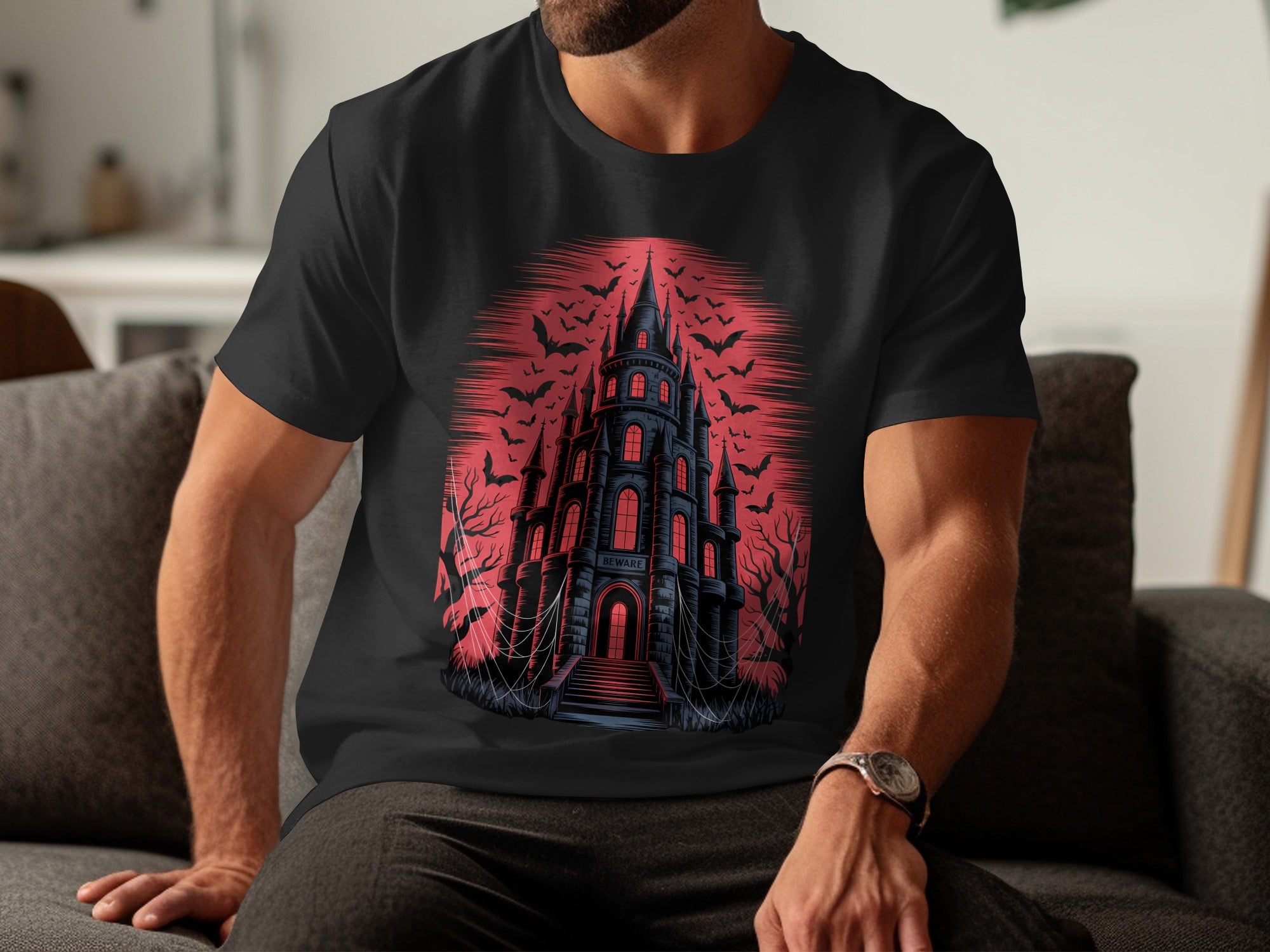 Person wearing a black t-shirt with a castle graphic design in red and black.