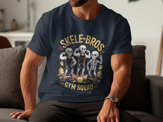 Person wearing a navy blue t-shirt with 'Skele-Bros Gym Squad' design sitting on a couch.