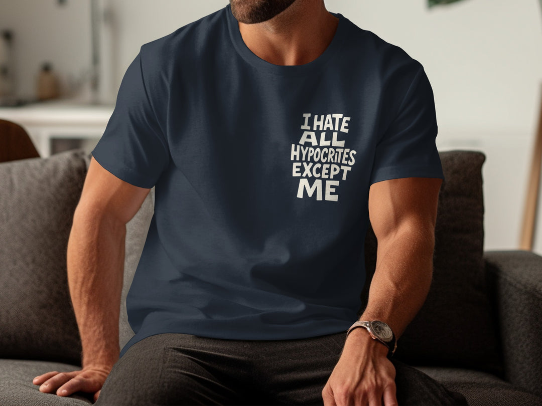 Person wearing a navy blue t-shirt with text sitting on a couch.