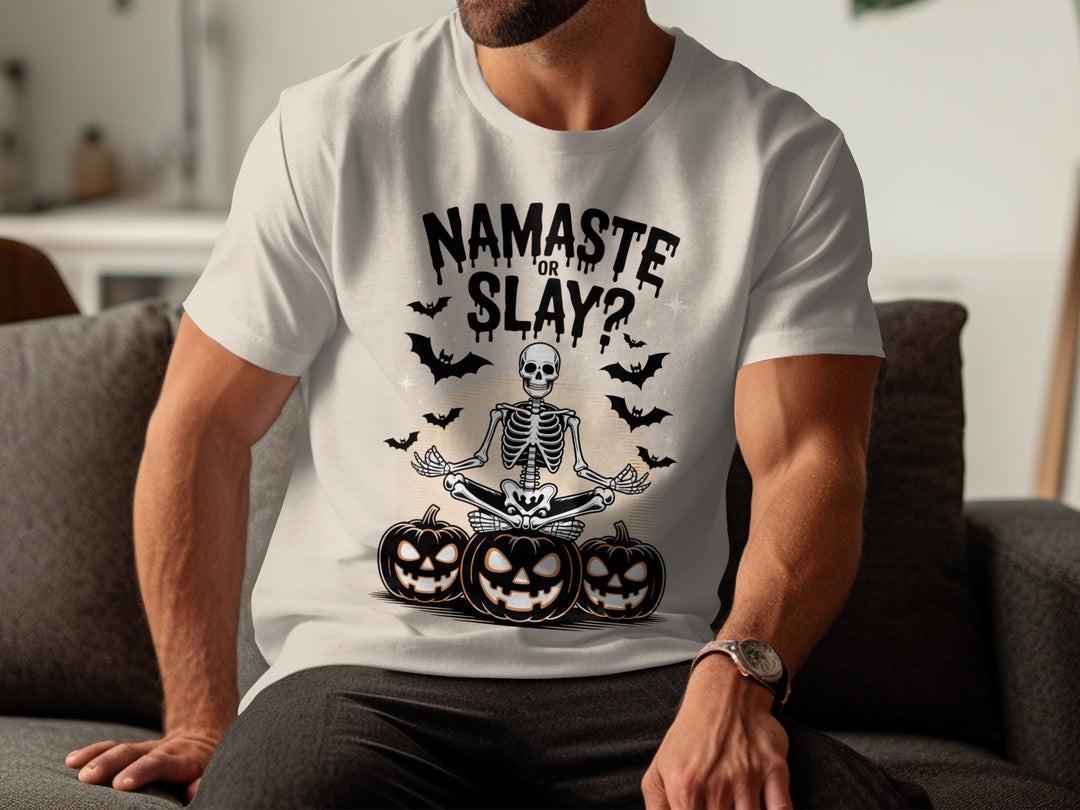 Person wearing a natural color t-shirt with Halloween-themed design featuring a skeleton and pumpkins.