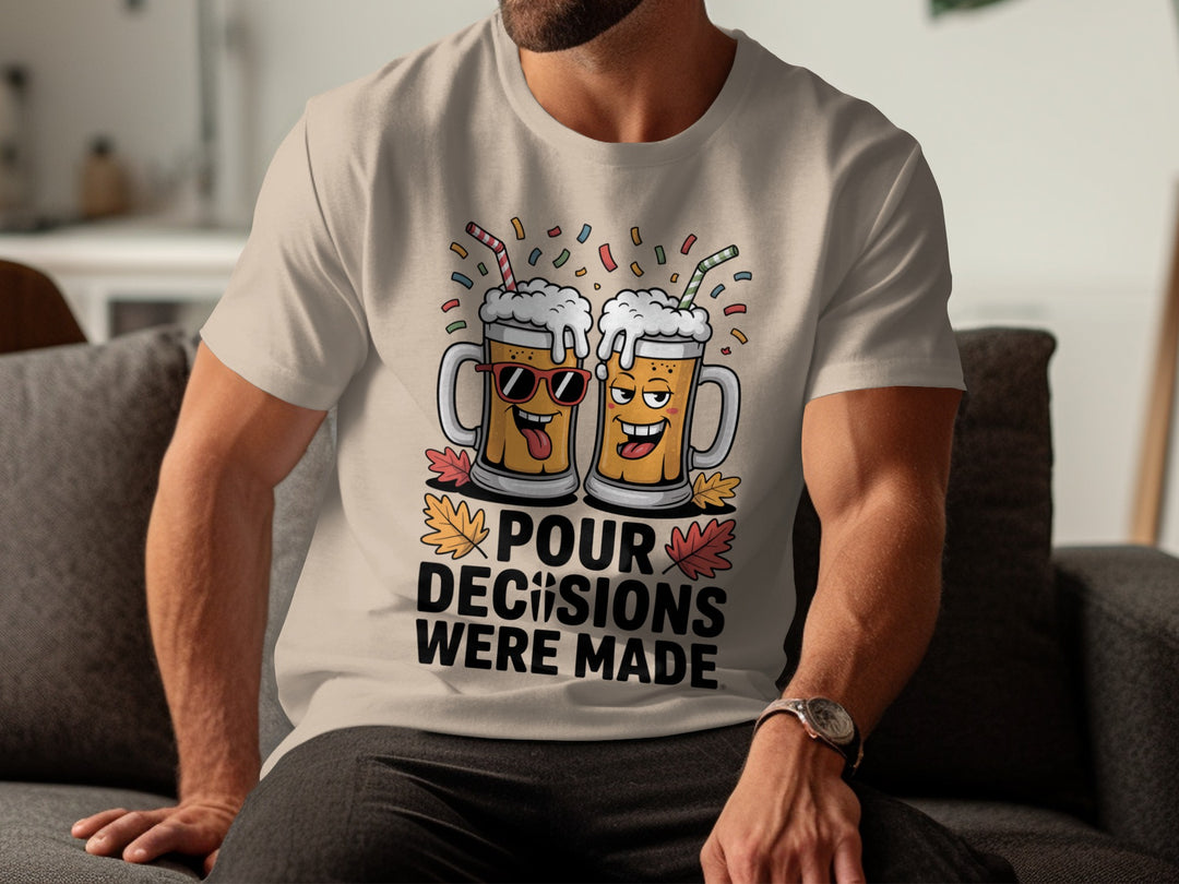 Person wearing a sand color t-shirt with a graphic design and text, sitting on a couch.