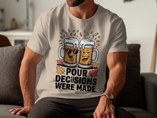 Person wearing a sand color t-shirt with a graphic design and text, sitting on a couch.