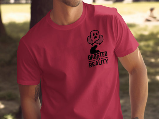 Red t-shirt with a graphic design and text worn by a person outdoors.