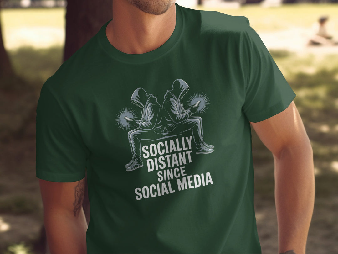 Person wearing a green t-shirt with a graphic and text 'Socially Distant Since Social Media' outdoors.