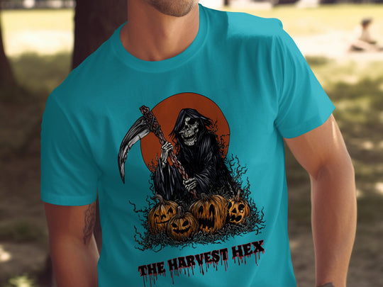 Person wearing a blue t-shirt with a graphic design of a skeleton holding a scythe and pumpkins, with text 'The Harvest Hex'.