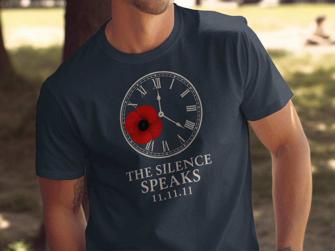 Person wearing a navy blue t-shirt with a clock and poppy design, text 'The Silence Speaks' and date '11.11.11'.