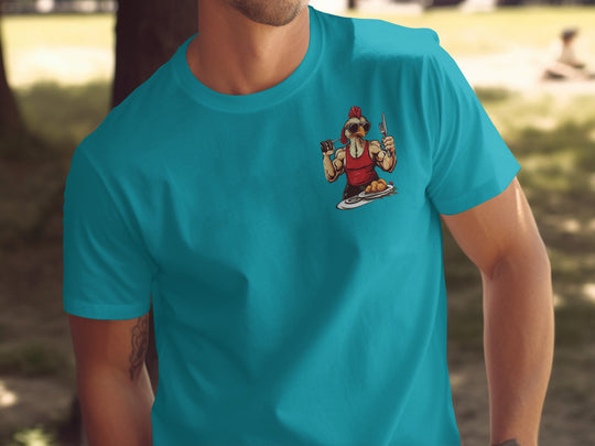 Person wearing a turquoise t-shirt with a graphic design of a cartoon character outdoors.