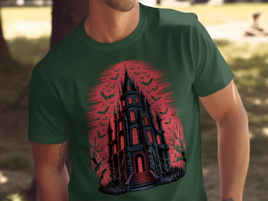 Person wearing a green t-shirt with a red and black castle design outdoors.