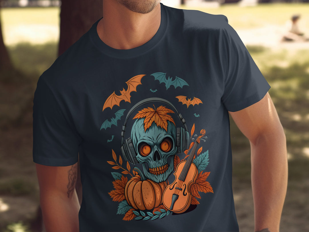 Person wearing a navy t-shirt with a Halloween-themed design featuring a skull, pumpkins, and bats.